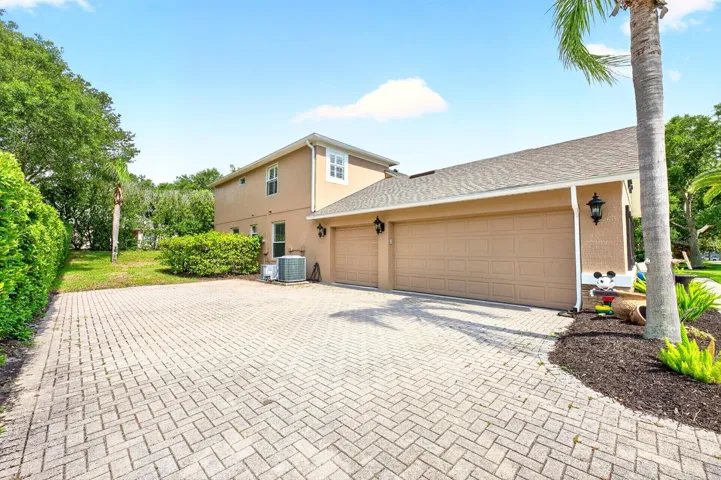 Paver driveway, 3-car side facing garage.