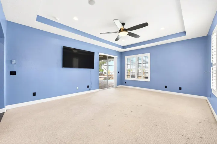 The main floor primary suite becomes your tranquil retreat with direct access to the lanai/pool.