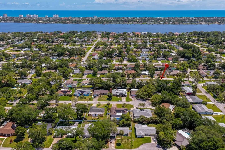 Spectacular panoramic aerial highlighting the home's proximity to the beautiful Halifax River and the Atlantic Ocean. This viewpoint captures the ultimate relaxed coastal lifestyle that the neighborhood offers.