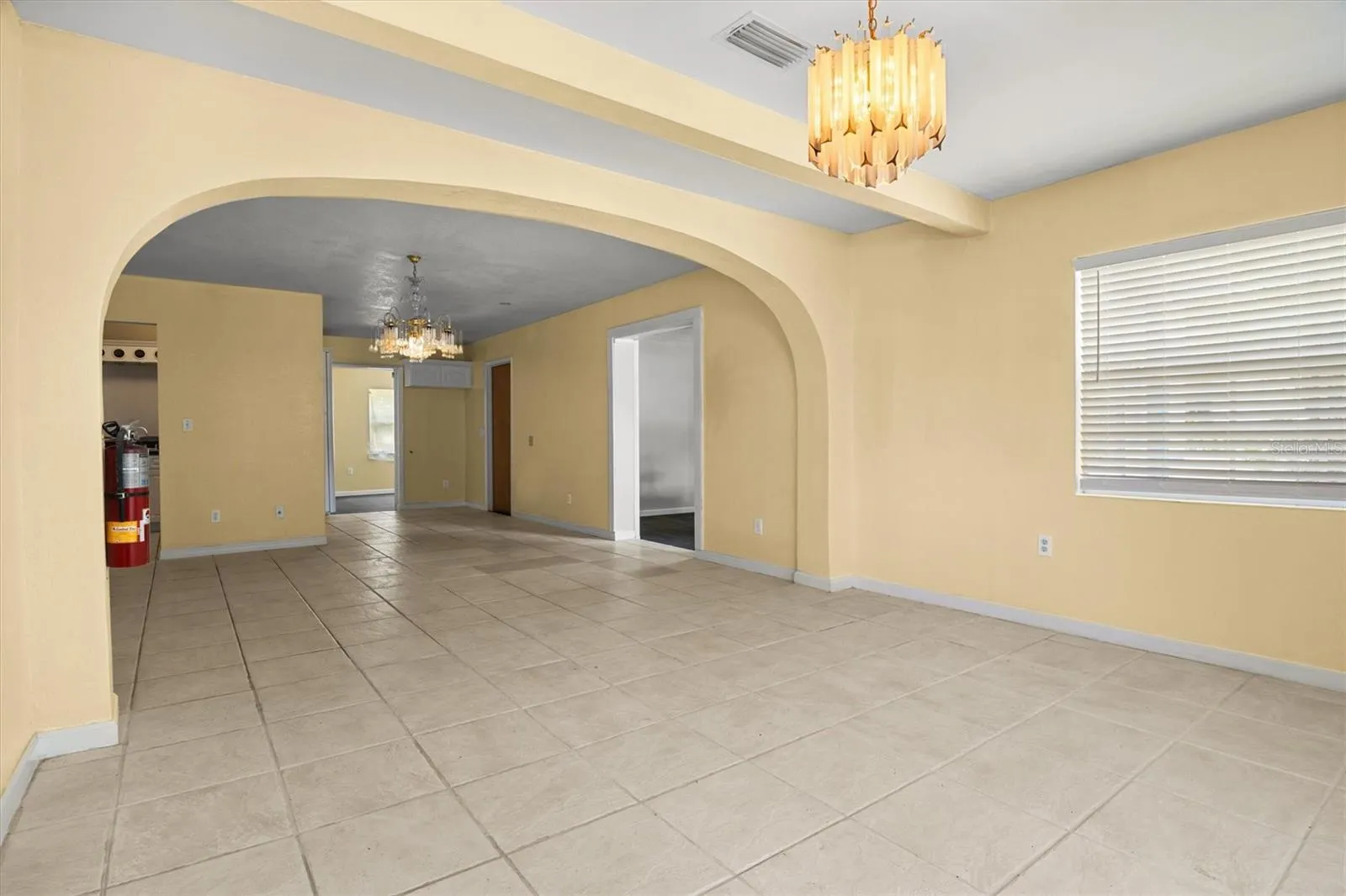 View of the living room and dining room from the front door.