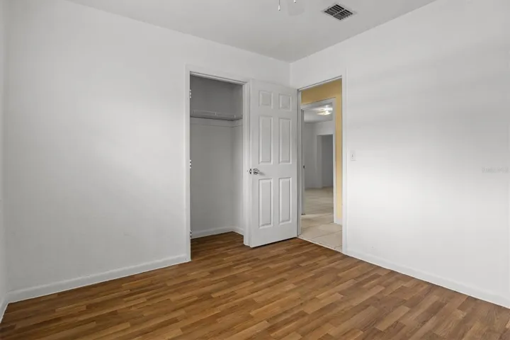 Guest bedroom with newer vinyl flooring