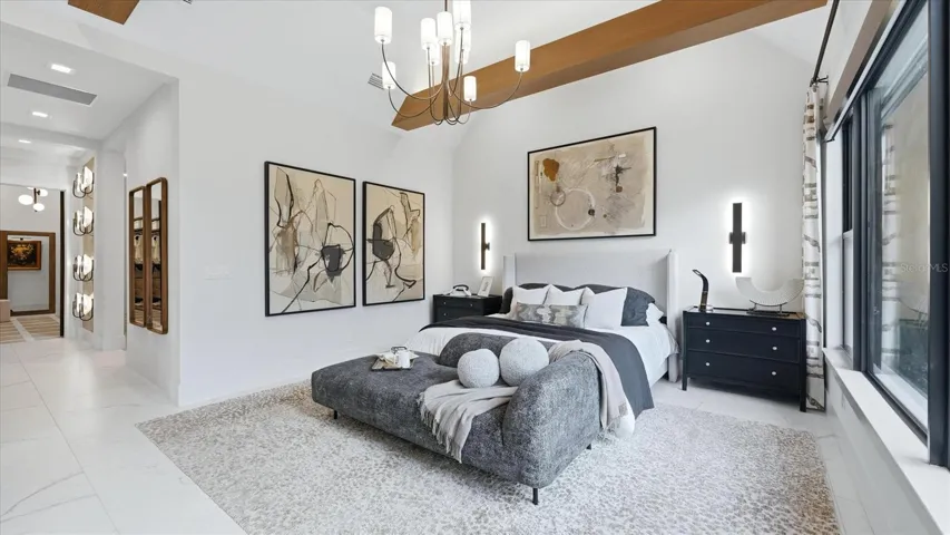 Primary bedroom with abundant natural light and a water view