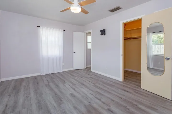 Primary bedroom with walk-in closet and door into en-suite bathroom