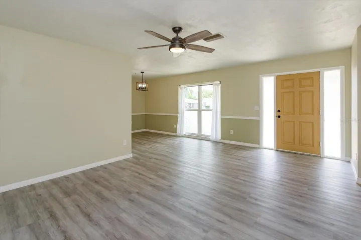 from living room looking to front door and dining room