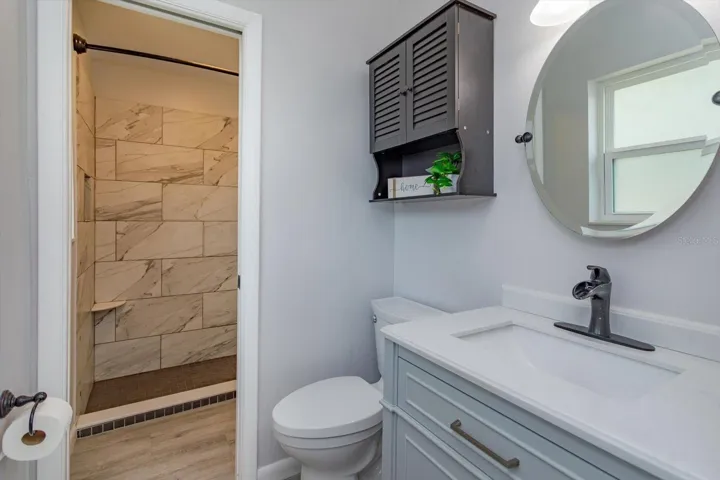 Primary bathroom looking into shared shower room