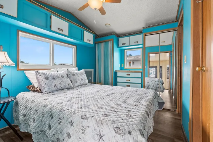 Spacious bedroom with built in cabinet overlooks the rear of the property and canal