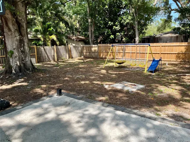 Privacy fenced back yard with patio
