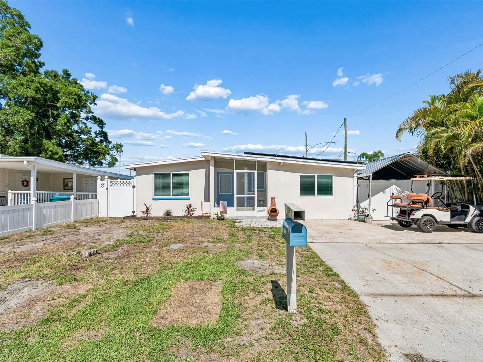 Large driveway with gate to carport