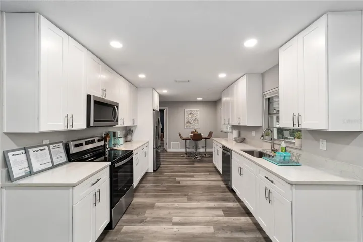 Galley kitchen with quartz countertops and new white cabinets