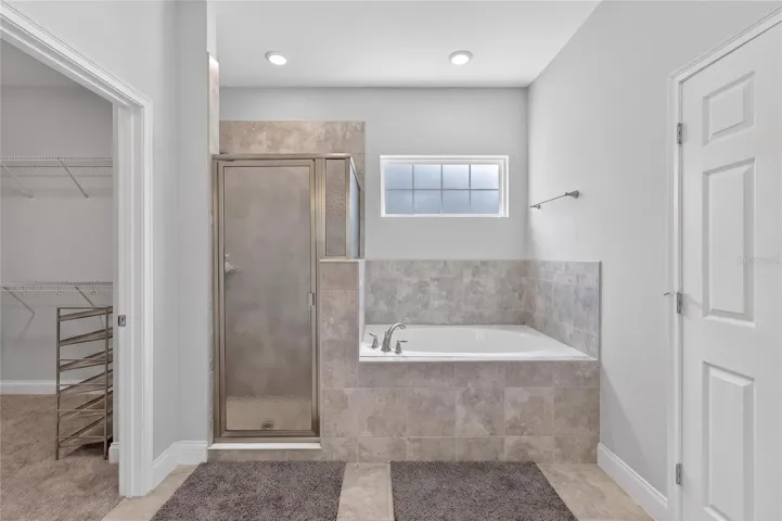 Dual vanities, tiled shower, and relaxing garden tub.
