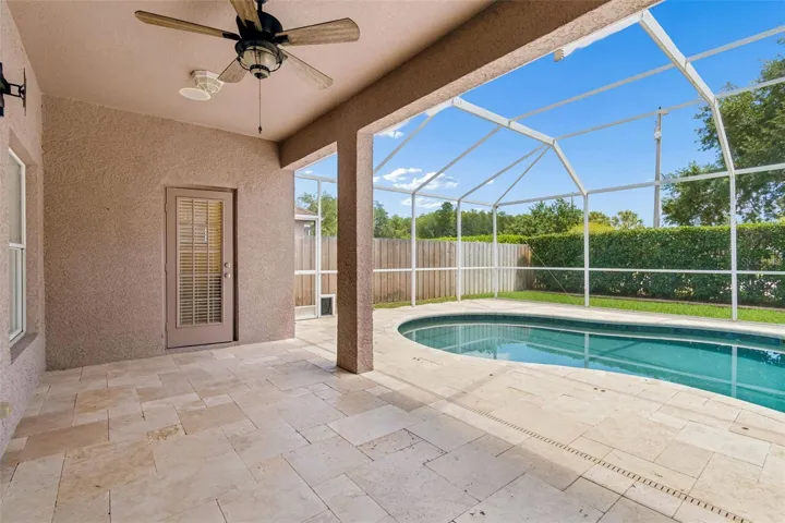 covered patio, travertine deck & screened in pool