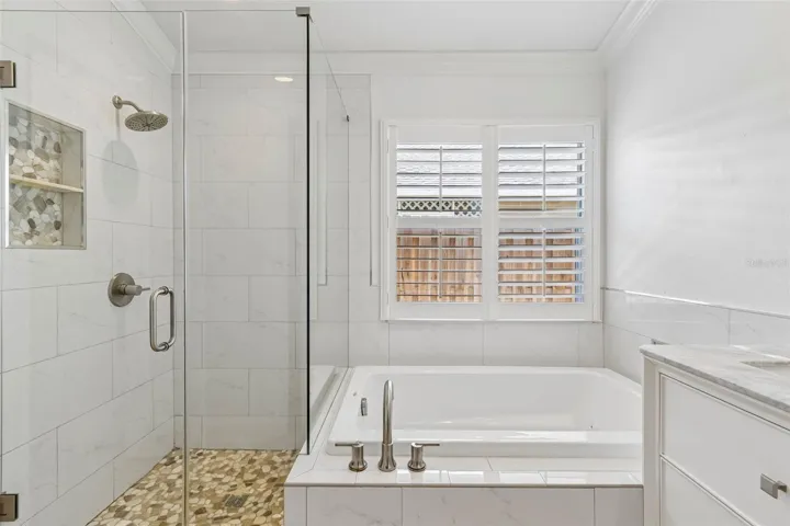 with soaker tub, double sinks and walk in shower