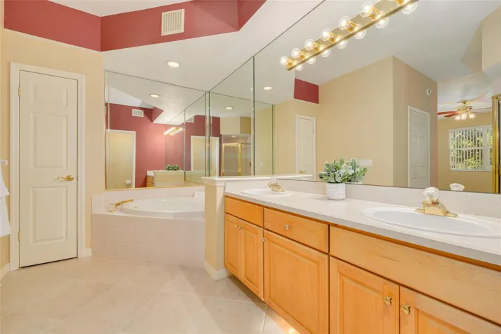Garden tub and dual sinks in the generously-sized primary bathroom.