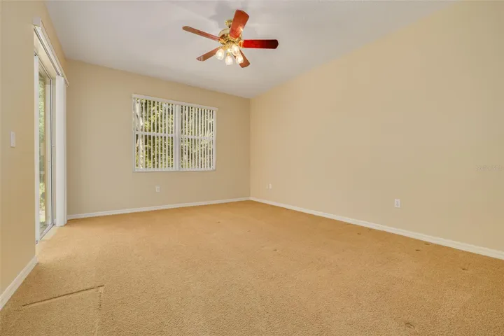 Primary bedroom with sliders on left