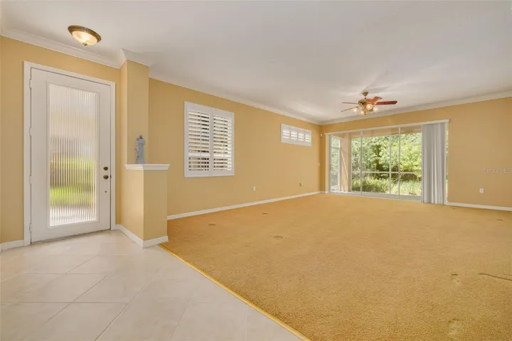 Living room with sliders to the lanai that overlooks conservation!