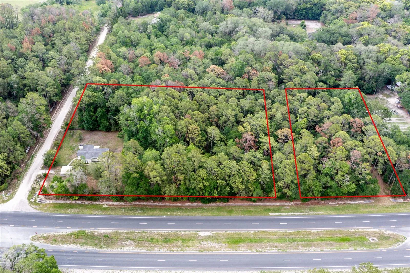 This aerial shows the entire 5.58 acres in two red outlined parcels