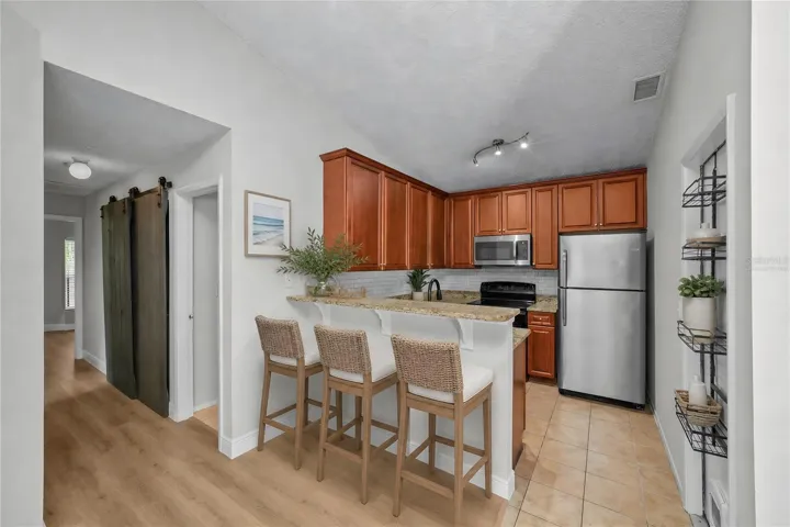 Virtually Staged -The kitchen offers ample cabinet storage and easy access to the dining and living areas, making everyday living a breeze.