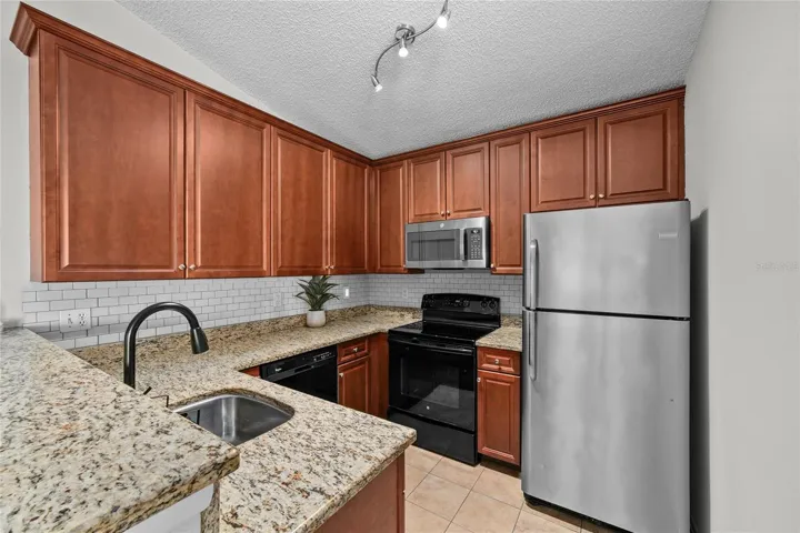 Kitchen with granite countertops and all appliances convey.