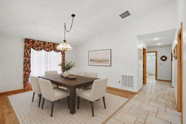Dining room, to the right arebathroom 2 and bedrooms 2and 3, both with stunning lakeviews-virtually staged