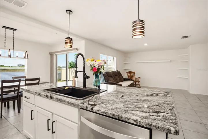 Designer pendant lighting, premium sink, and upgraded faucet. Move-in ready kitchen upgrades in Evergreen, Bradenton FL