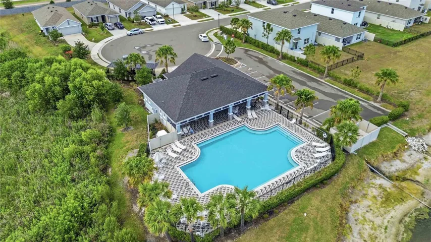 Aerial views don't lie -Sun loungers, palm trees, and sparkling blue water at the community pool!
