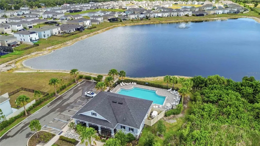 Aerial views don't lie -Sun loungers, palm trees, and sparkling blue water at the community pool!
