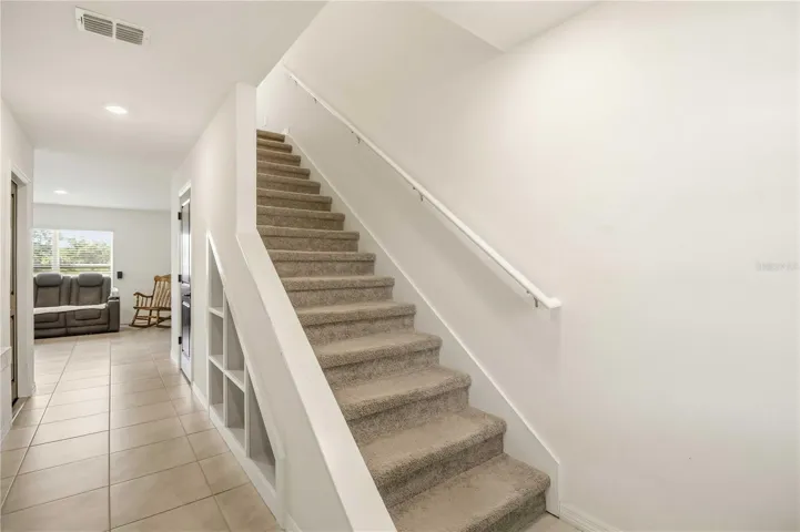 Custom built-in shelving at entry. Upgraded move-in ready home