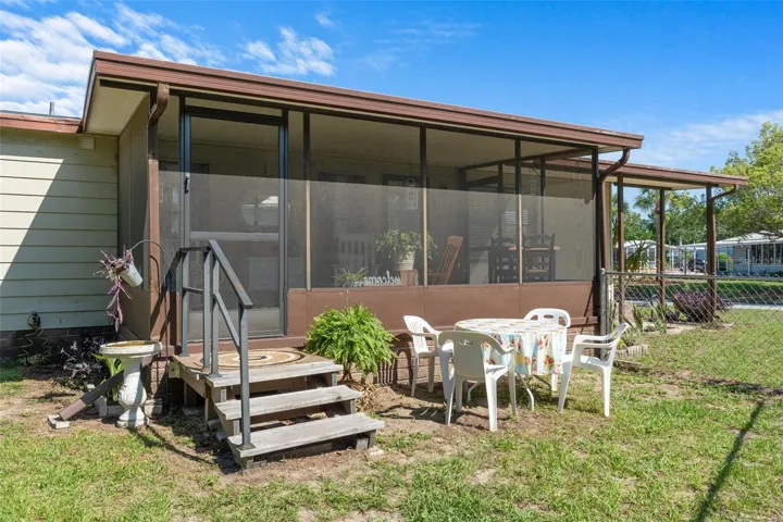 Steps from screen room to backyard