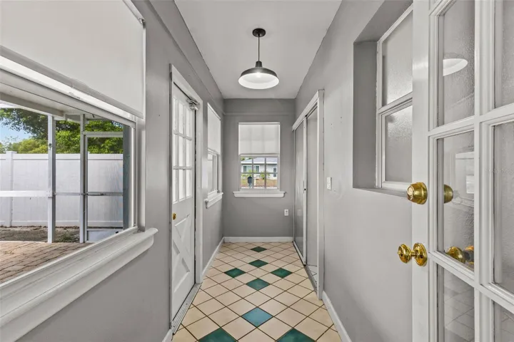 Hallway to second full bath, laundry and pool
