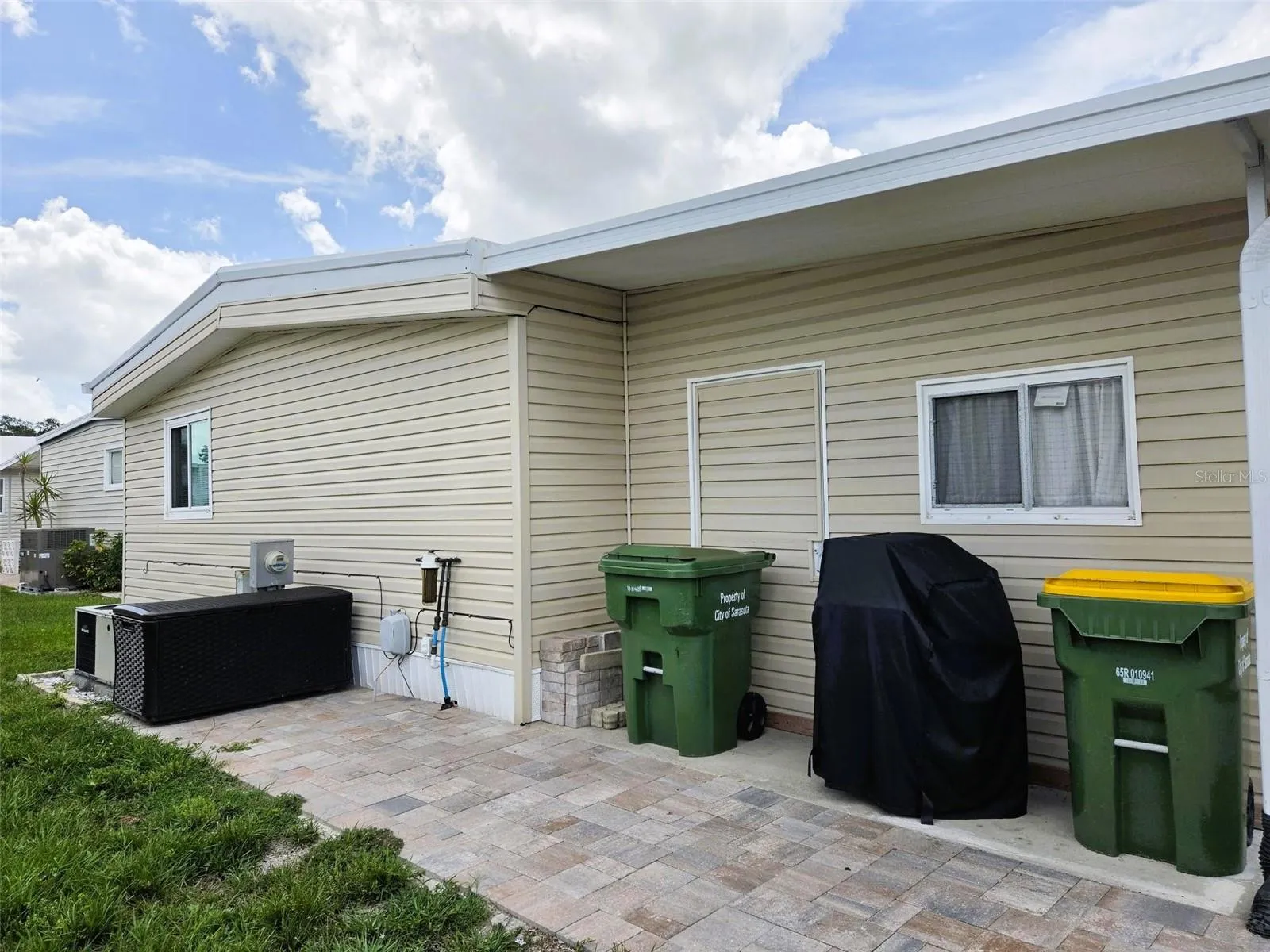 Back of home with paver walkway