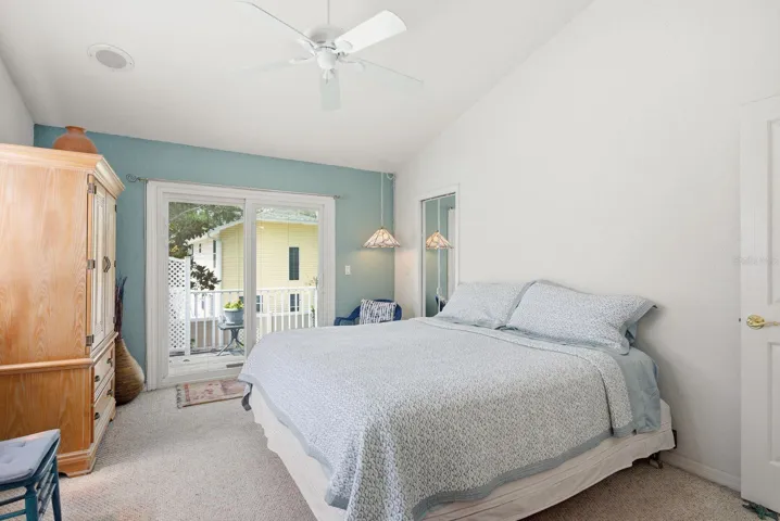 Upstairs Primary bedroom (3). Hurricane rated sliders with built in blinds lead to balcony.