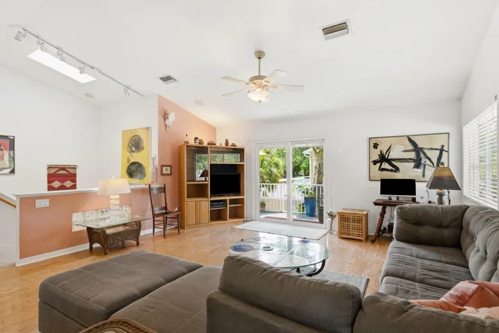 Living room with skylight over stairs.