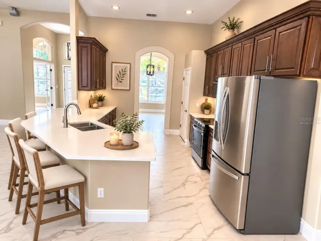 This photo has been virtually staged.  View of kitchen looking toward the dining room at the front of the house.