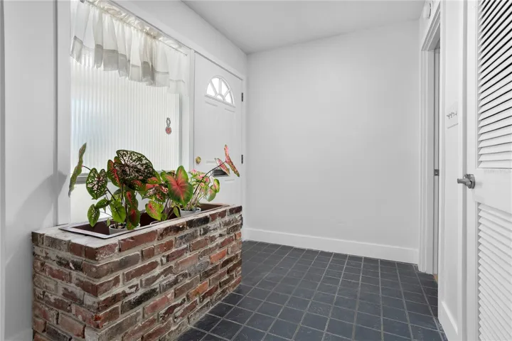 Front entry with original mid-century planter box.  Keep, or not, flooring material is provided.
