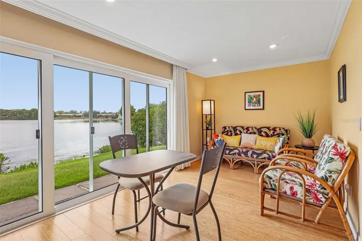 The Dining area enjoys peaceful backyard and LAKE VIEWS and features sliding glass doors that invite NATURAL LIGHT inside while enhancing the home's indoor-outdoor feel.
