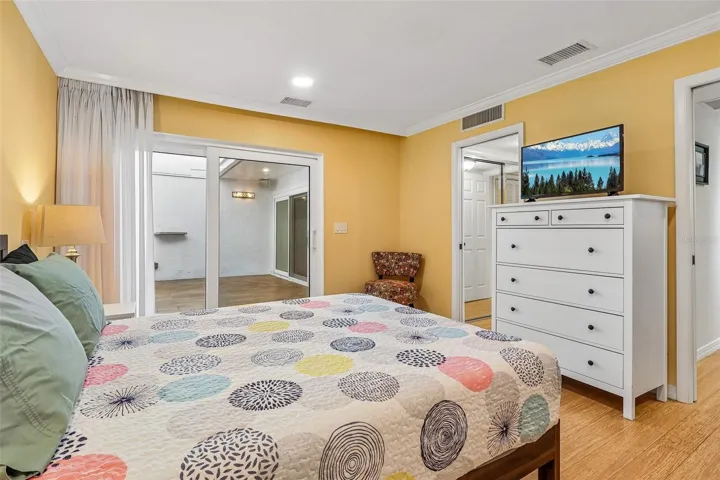 The Primary Suite provides a TRANQUIL ESCAPE, featuring sliding doors leading directly to the conservatory, dual closets, and an EN SUITE BATH.
