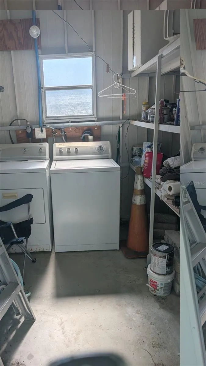 Outdoor utility/storage shed with washer and dryer.