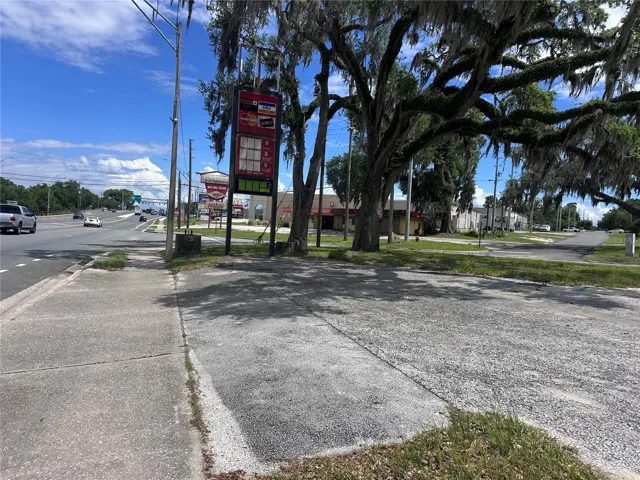 Veiw to the west corner, includes the large concrete stand for a sign, and the existing signage on corner next to oak trees this veiw is of Hwy 41 and East Grace street as they meet just beyond large sign and a bock away is one of the neighborhood shoping plazas