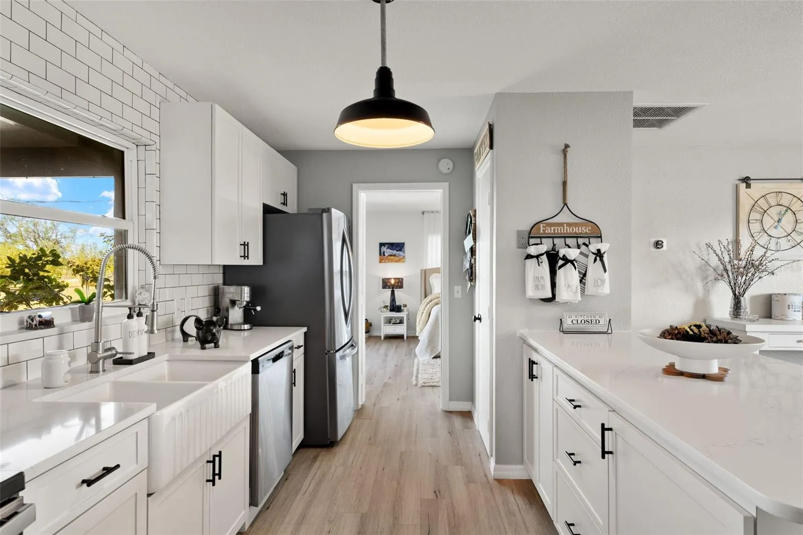 Double bowl farm sink with high-arc faucet on the left