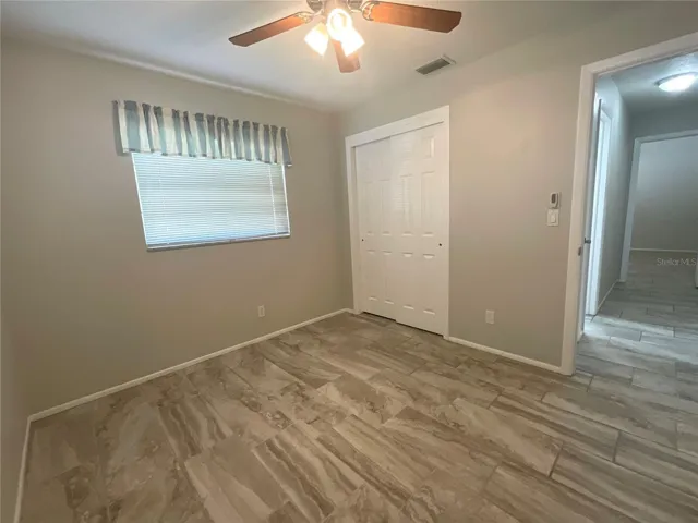 Guest bedroom view of window and closet