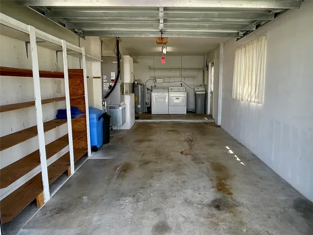 One car garage with laundry utility area as you step out of kitchen.