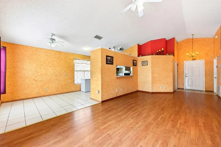 Open concept living under a vaulted ceiling.