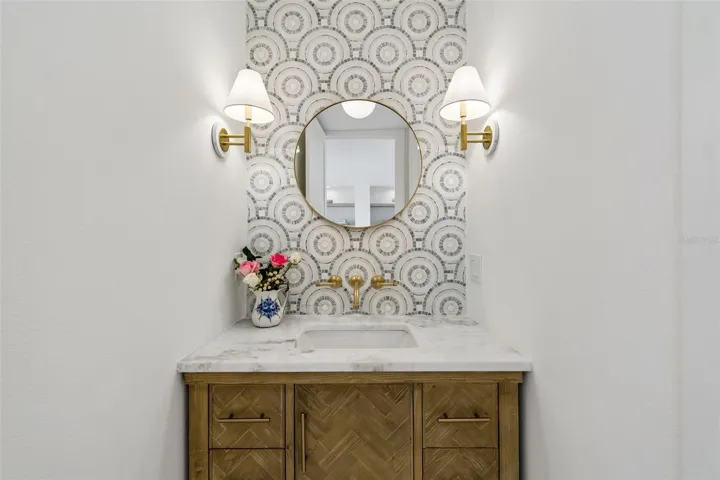 Powder room w/mosaic tile backsplash, upscale fixtures and lighting