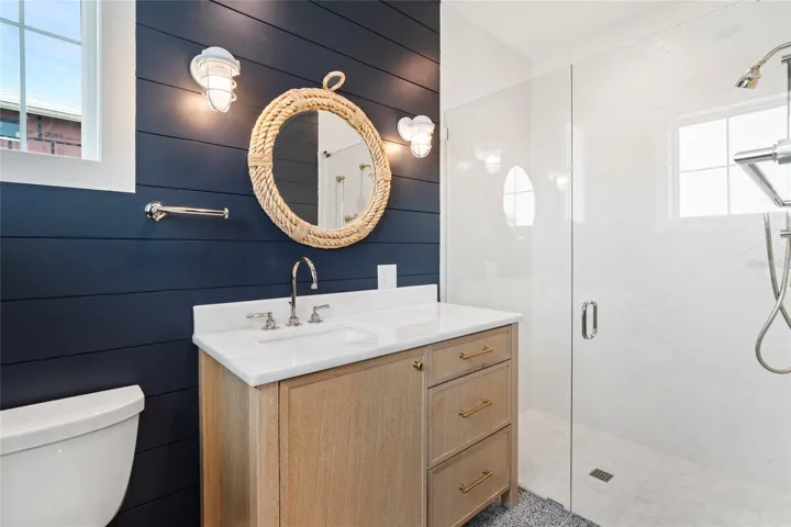 guest suite bath w/ custom cabinetry, upscale lighting and fixtures