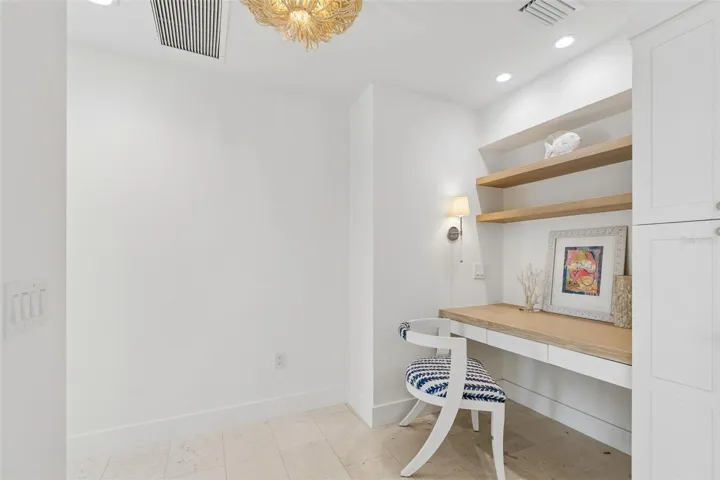 Master suite office area with shell stone tile