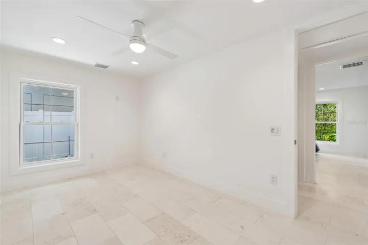 edroom 4 with shel stone flooring and double closets