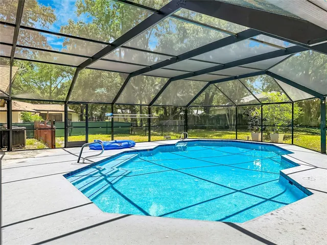 Private pool area surrounded by lush mature landscaping