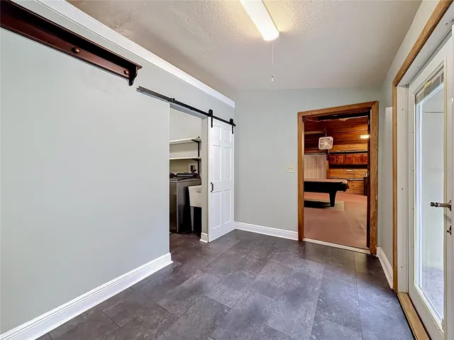Well-designed hallway with easy access to garage, laundry, and outdoor pool