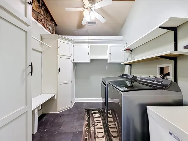 Spacious laundry area featuring ample cabinetry