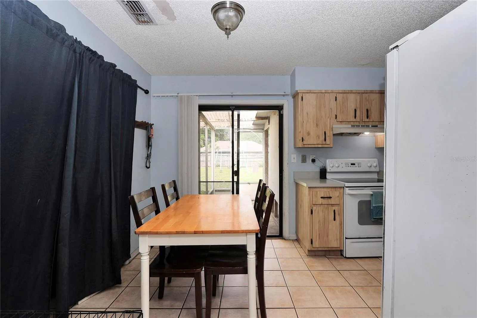 Dining room with sliding glass door to back porch and large pantry closet